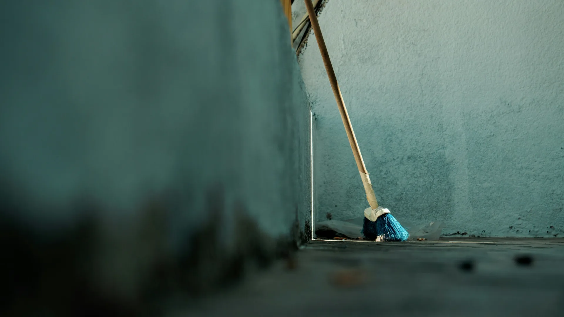 Old musky basement with a broom